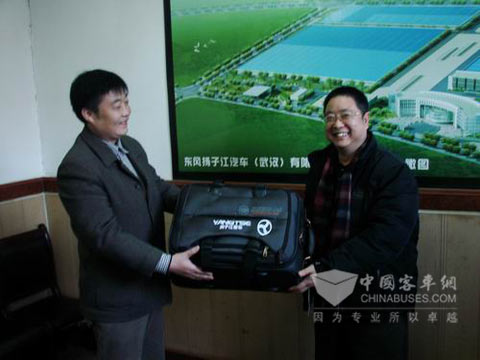 Mr. Huang delivering suitcase with company logo and new working clotehs to personals to Burma 
