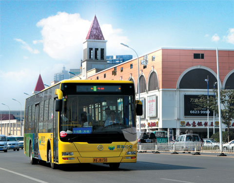 The hybrid bus of Golden Dragon is driving on the road